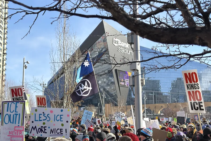 Image of the protest on January 23 with signs such as "No Kings, No ICE."