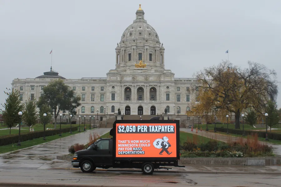 Photo of a mobile billboard truck in front of Minnesota's State Capitol building. The billboard reads: $2,050 PER TAXPAYER THAT'S HOW MUCH MINNESOTA COULD PAY FOR MASS DEPORTATIONS